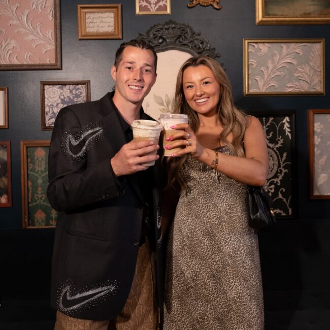 Guests toasting with iced coffee drinks from The Thirsty Filly coffee bar at an event